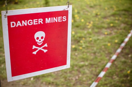 Warning sign - Danger mines on a forest.の写真素材