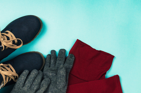 Woman clothes and boots on a blue background. Winter concept. top view.の写真素材
