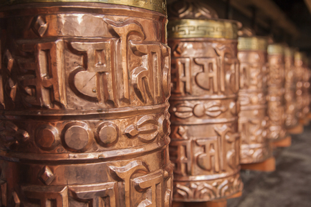 PANGBOCHE, NEPAL - CIRCA OCTOBER 2013: prayer wheel used in Tibetan Buddhism to the rotational axis of the cylinder inscribed with mantras surface circa October 2013 in Pangboche.の写真素材