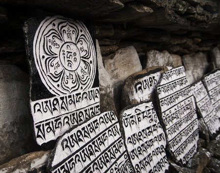 CHAURIKHARKA, NEPAL - CIRCA OCTOBER 2013: Mani stones with the inscription mantra is one of the elements of the Buddhist religion circa October 2013 in Chaurikharka.の写真素材