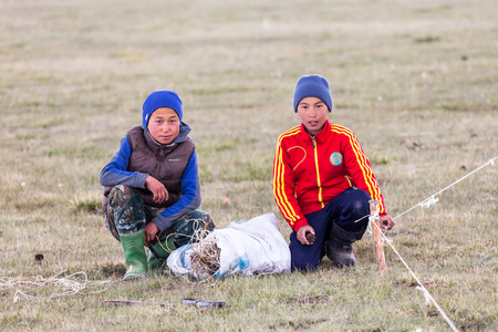 SONG KUL, KYRGYZSTAN - CIRCA JUNE 2017: Children of one of the camps at Song Kul  high alpine lake in the Tian Shan Mountains of Kyrgyzstan circa June 2017 in Song Kul.のeditorial素材