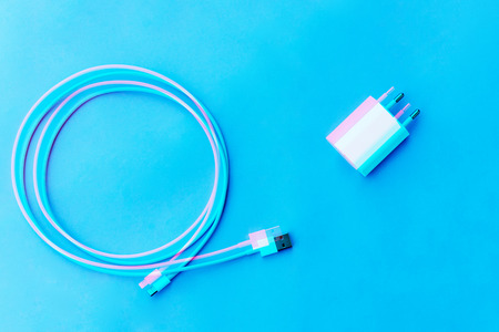 charger power and wire on a blue background. Top view of the place for the text. Digital signal ...