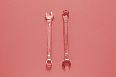 Two Spanner keys on Living coral  background. Screw driver set. Wrench spanners. Background for your text and design.の写真素材