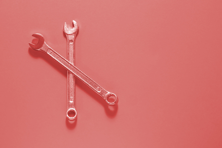 Two Spanner keys on Living coral  background. Screw driver set. Wrench spanners. Background for your...