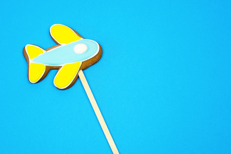 Gingerbread airplane  on blue background, tourism, air travel, logistic conceptの写真素材
