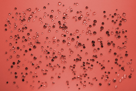 Crystals. Crystal strasses on a abstract  Living coral background. Beautiful shiny sparkling silver rhinestones. Jewelry, rhinestones, shiny stones.の写真素材
