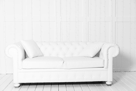 White room with sofa and empty background wall with LED garlandの写真素材