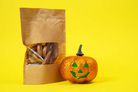 craft package with transparent top with tasty dried snacks for pets inside with halloween pumpkin...