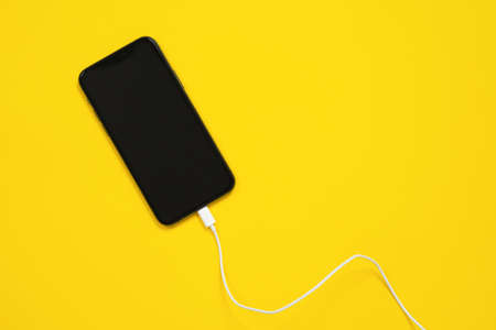 May 01, 2020, Rostov, Russia: Smartphone is facing up, usb lightning cable or wired headphones are...