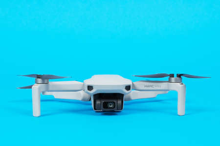 June 05, 2020, Rostov, Russia: Modern drone quadcopter DJI Mavic 2 Pro with open propeller blades with a camera isolated on blue background.のeditorial素材