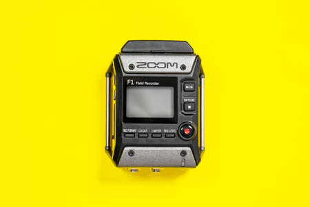 April 11, 2020, Rostov-on-Don, Russia: Zoom audio recorder with buttons and screen, laying on bright yellow background. Sound record equipment, close up, studio, copy space.のeditorial素材