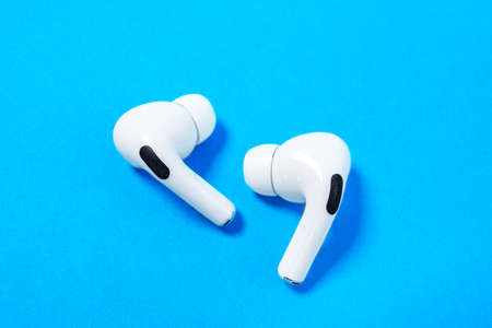 Rostov, Russia - July 06, 2020: Apple AirPods Pro on a blue background. Silent wireless headphones...