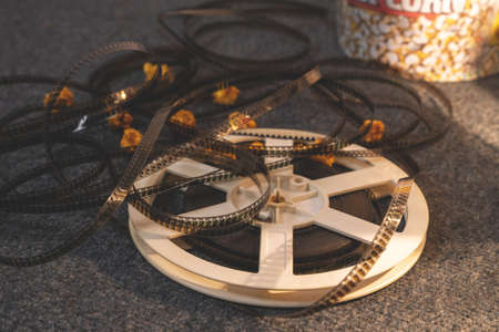 Old-school reel of uncoiled film is lying on the floorの写真素材
