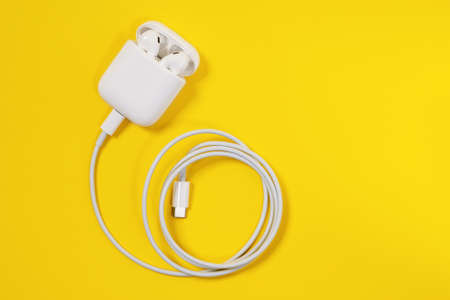 Rostov, Russia - July 06, 2020: Apple AirPods wireless Bluetooth headphones and charging case for Apple iPhone, wire lightning to usb type c. New Apple Earpods Airpods in boxのeditorial素材