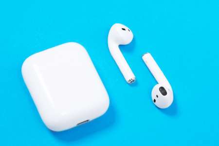 Rostov, Russia - July 06, 2020: Apple AirPods wireless Bluetooth headphones and charging case for...