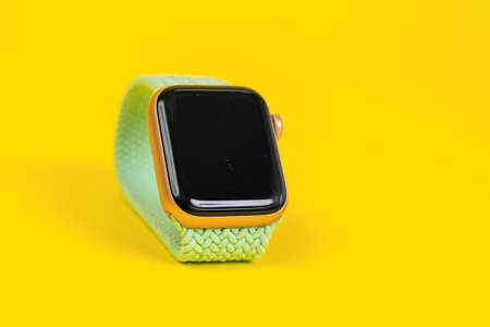 May 29, Rostov, Russia: Apple Watch Series 6 with pistachio braided solo loop as a modern band on yellow background, copy space. Smart device for an active lifestyleのeditorial素材
