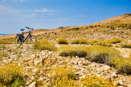 a lonely bicycle in front of a barren landscape in Croatia on island Pagの写真素材