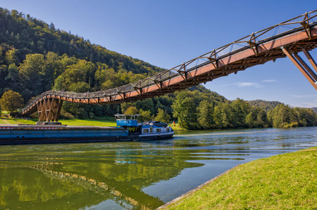 a barge is passing under the second longest wooden bridge in Europe on the main-Danube canal in...