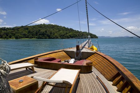 Front deck of yacht with chairs sailing in the oceanの写真素材