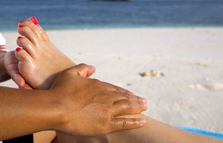 A foot massage on the beachの写真素材