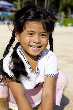 Portrait on a little Thai girl on the beachの写真素材