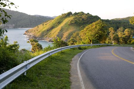 A  winding road with beautiful sea views and mountainsの写真素材