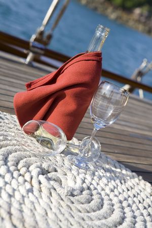 A bottle of wine on the wooden deck of a yachtの写真素材