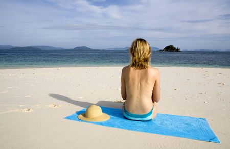 A sexy woman sunbathing on the beachの写真素材