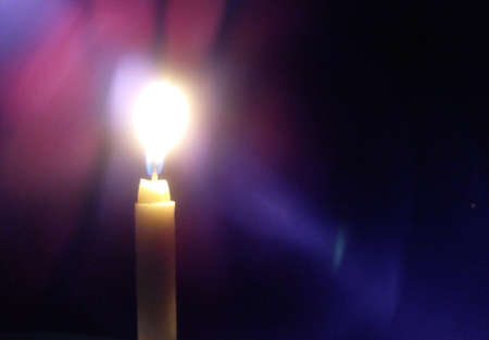 A candle is lit when the lights go out in the houseの写真素材