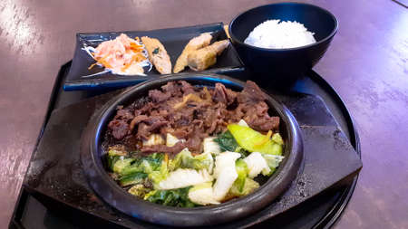 Rice food with beef and vegetables in black plateの写真素材