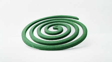 Mosquito coil on a white background, closeup of photo