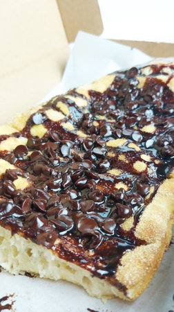 waffle with chocolate topping on white paper box, selective focus.の写真素材