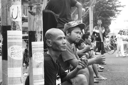 Black and white portrait of men sitting together relaxing, Surakarta, Indonesia.のeditorial素材