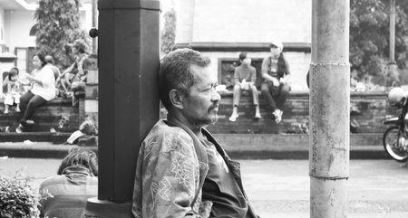 Black and white portrait of an old man sitting in deep thought with a blank stare, Surakarta, Indonesia.のeditorial素材