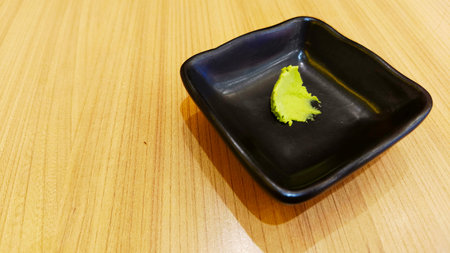 Sushi on a black plate on a wooden table, Japanese food