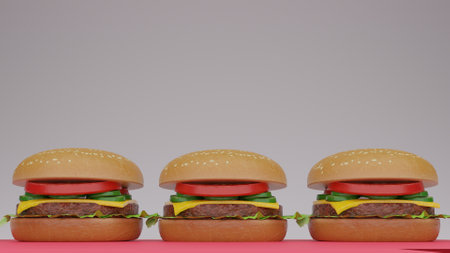 Three hamburgers on a pink table against a grey background.の写真素材