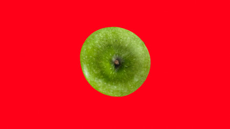green apple with red backgroundの写真素材