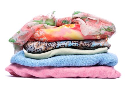 Stacks of women colored clothes on white backgroundの写真素材