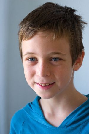 Portrait of boy with blue eyes on gray background