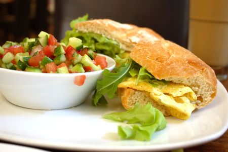 Breakfast - baguette with omelette and green saladの写真素材