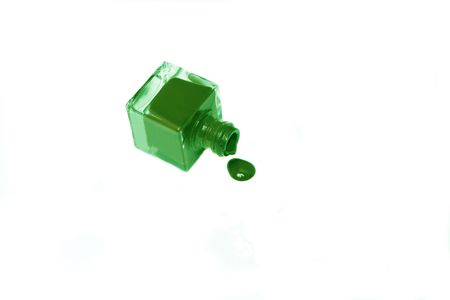 green nail polish bottle with splatters isolated on white background.の写真素材