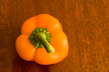 orange pepper on wood tableの写真素材