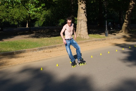 Hyde Park, London, United Kingdom - August 31, 2009. Roller (caucasian man) skating slalom.のeditorial素材