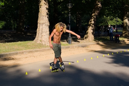 Hyde Park, London, United Kingdom - August 31, 2009. Roller (caucasian man) skating slalom.のeditorial素材