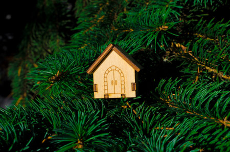 small decorative Christmas wooden pendant on a spruce branch. High quality photoの写真素材