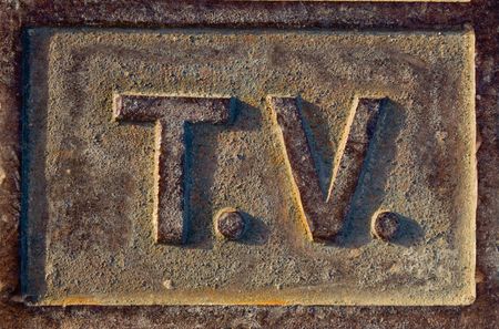 A metallic sign which is rusty and brown spelling TVの写真素材