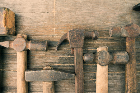 Retro shabby hammers on an old dirty grunge wooden background. Ideal for mock ups designs. Vintage toningの写真素材