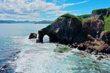 Aerial view Top down seashore. Waves crashing on rock cliff. Beautiful sea surface in sunny day summer background seascape top view seacoastの写真素材