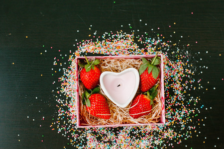 Strawberry and white candle in a boxの写真素材