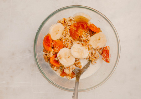Granola with banana and Dried apricots in a bowlの写真素材